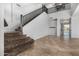 Foyer with neutral tile flooring and a carpeted staircase leading to the second floor at 15357 W Post Cir, Surprise, AZ 85374