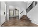 Foyer with neutral tile flooring and a carpeted staircase leading to the second floor at 15357 W Post Cir, Surprise, AZ 85374