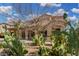 Landscaped front yard with desert plants and covered parking at this beautiful home at 15357 W Post Cir, Surprise, AZ 85374