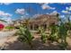 Landscaped front yard with desert plants and covered parking at this beautiful home at 15357 W Post Cir, Surprise, AZ 85374