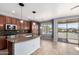 Bright kitchen featuring stainless appliances, island with sink, and backyard access at 15357 W Post Cir, Surprise, AZ 85374