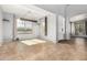 Open-concept living room with tile floors, large windows, and unique chandelier at 15357 W Post Cir, Surprise, AZ 85374