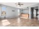 Open living room with tile floors and built-in cabinetry and shelving at 15357 W Post Cir, Surprise, AZ 85374