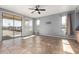 Spacious living room features tile floors, sliding glass doors, and a large window at 15357 W Post Cir, Surprise, AZ 85374