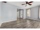Inviting living room with wood-look floors, ceiling fan, and views to the entry at 15357 W Post Cir, Surprise, AZ 85374