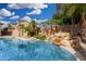 Backyard pool with a waterfall feature and lush landscaping at 15357 W Post Cir, Surprise, AZ 85374