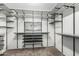 Spacious walk-in closet featuring adjustable shelving, shoe racks and ample storage, perfect for organization at 15357 W Post Cir, Surprise, AZ 85374