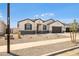 Attractive single-Gathering house with a xeriscaped front yard, complemented by dark shutters and trim at 15414 W Cottontail Ln, Surprise, AZ 85387