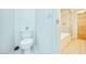 Bright bathroom with a toilet, white tiled floors, and a shower/tub at 1612 E South Mountain Ave, Phoenix, AZ 85042