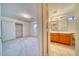 A bright bedroom features a large window, closet with sliding doors, and neutral carpet flooring at 1612 E South Mountain Ave, Phoenix, AZ 85042