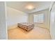 Bright bedroom features neutral carpeting and a window with natural light at 1612 E South Mountain Ave, Phoenix, AZ 85042