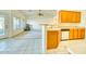 Bright kitchen with wood cabinets and views of the Gathering room, with a breakfast bar at 1612 E South Mountain Ave, Phoenix, AZ 85042