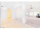 Bright, open-concept living area with tile flooring, neutral carpeting, and ample natural light at 1612 E South Mountain Ave, Phoenix, AZ 85042