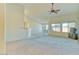 Spacious living room featuring a ceiling fan, large windows, and seamless transition to the dining area at 1612 E South Mountain Ave, Phoenix, AZ 85042