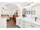 Bathroom with arched doorway leading to bedroom, featuring a double vanity and modern fixtures at 16447 N 29Th Ln, Phoenix, AZ 85053