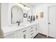 Modern bathroom with double sinks, white cabinets, stylish mirrors, and contemporary fixtures at 16447 N 29Th Ln, Phoenix, AZ 85053