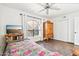 Bright bedroom with large window, ceiling fan, tiled floor and closet space at 16447 N 29Th Ln, Phoenix, AZ 85053