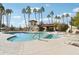 Community pool featuring clear blue water, palm trees, lounge chairs, and a poolside structure at 16447 N 29Th Ln, Phoenix, AZ 85053