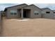 Large backyard featuring a patio and block fence for privacy at 17449 W Eva St, Waddell, AZ 85355