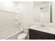 Modern bathroom featuring a shower-tub combo, white vanity with dark wood cabinets, and a large mirror at 17449 W Eva St, Waddell, AZ 85355