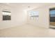 Well-lit bedroom with neutral walls, large windows, and a sliding glass door at 17449 W Eva St, Waddell, AZ 85355