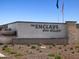 Attractive community sign with stone accents and manicured landscaping at 17449 W Eva St, Waddell, AZ 85355
