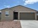 Inviting single-story home with a two-car garage and drought-tolerant landscaping at 17449 W Eva St, Waddell, AZ 85355