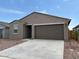 Charming single-story home with a two-car garage and low-maintenance desert landscaping at 17449 W Eva St, Waddell, AZ 85355
