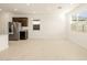 Open-concept kitchen featuring stainless steel appliances and bright natural light from the large windows at 17449 W Eva St, Waddell, AZ 85355