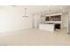 Open-concept kitchen with dark wood cabinets, stainless steel appliances, and a spacious island at 17449 W Eva St, Waddell, AZ 85355