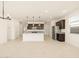 Bright open-concept kitchen with dark wood cabinetry, stainless steel appliances, and granite countertops at 17449 W Eva St, Waddell, AZ 85355
