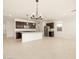 Open-concept kitchen with dark wood cabinetry, stainless steel appliances, and a spacious island at 17449 W Eva St, Waddell, AZ 85355