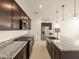 Modern kitchen showcasing stainless steel appliances, granite countertops, and ample cabinet space at 17449 W Eva St, Waddell, AZ 85355