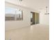 Well-lit living room featuring tile flooring and a sliding glass door with backyard access at 17449 W Eva St, Waddell, AZ 85355