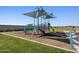 A modern playground features climbing structures, slides, and safety surfacing at 17449 W Eva St, Waddell, AZ 85355