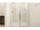 Modern shower with glass doors and built-in shelving for bath products at 17449 W Eva St, Waddell, AZ 85355