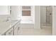 This bathroom features quartz countertops, a bathtub and glass shower at 17624 W Pierson St, Goodyear, AZ 85395