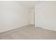 A view of a bedroom with neutral carpet, white walls, a closet, and a door at 17624 W Pierson St, Goodyear, AZ 85395