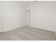 Empty bedroom with carpet flooring features multiple white doors and natural light filtering through the open doorway at 17624 W Pierson St, Goodyear, AZ 85395
