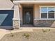 A close-up of the front entryway shows stone-accented columns supporting the porch and a blue front door at 17624 W Pierson St, Goodyear, AZ 85395