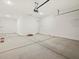 View of the garage with concrete floors and a door on the back wall at 17624 W Pierson St, Goodyear, AZ 85395