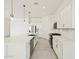 Open-concept kitchen with white cabinets, stainless steel appliances, quartz countertops, and a large island at 17624 W Pierson St, Goodyear, AZ 85395