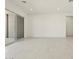 Bright living room features tiled floors and large sliding glass doors to back patio at 17624 W Pierson St, Goodyear, AZ 85395