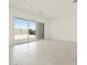 Bright living room features tiled floors and large sliding glass doors to back patio at 17624 W Pierson St, Goodyear, AZ 85395