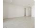 Spacious living room boasts neutral color scheme, recessed lighting, and tile flooring for a modern aesthetic at 17624 W Pierson St, Goodyear, AZ 85395