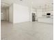 Spacious open-concept living room and kitchen with modern tile floors and neutral color palette create an inviting space at 17624 W Pierson St, Goodyear, AZ 85395