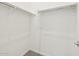 This walk-in closet provides convenient storage with hanging rods and shelves for a tidy and organized wardrobe at 17624 W Pierson St, Goodyear, AZ 85395