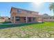 Backyard showcasing the exterior of the home, a green lawn, and a covered patio at 1870 E Indigo Dr, Chandler, AZ 85286