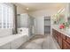 Spacious bathroom features a walk-in shower, soaking tub, and double sink vanity at 1870 E Indigo Dr, Chandler, AZ 85286