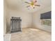 This bedroom features a neutral color palette, ceiling fan, window, and tile flooring at 1870 E Indigo Dr, Chandler, AZ 85286